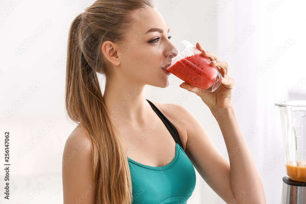 Young woman drinking healthy smoothie at home Young woman drinking healthy smoothie at home