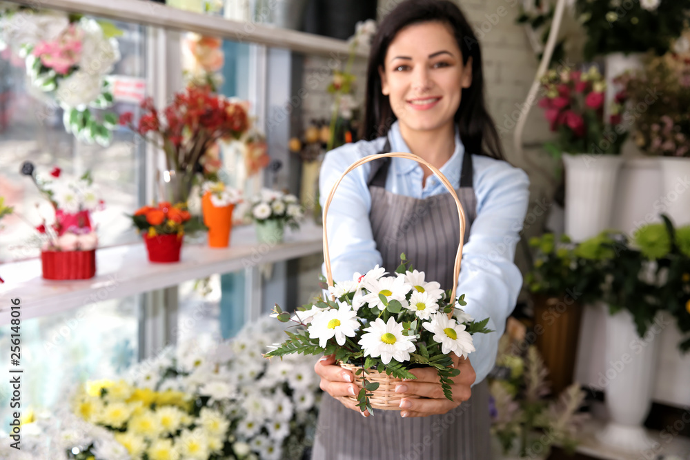 Female owner with beautiful flowers in shop Female owner with beautiful flowers in shop
