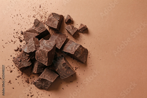 Sweet tasty chocolate on color background