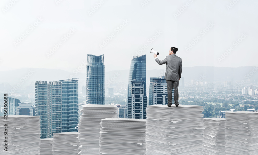 Businessman standing with megaphone.