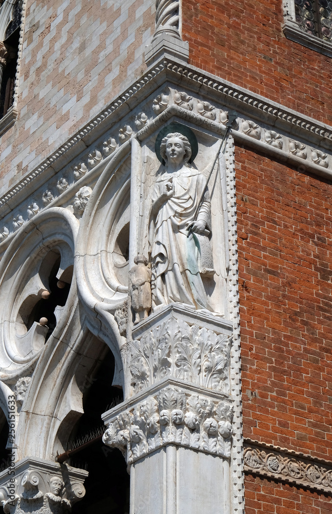 Sculpture of Archangel Raphael with Tobias, detail of the Doge Palace, St. Mark Square, Venice, Italy, UNESCO World Heritage Sites 