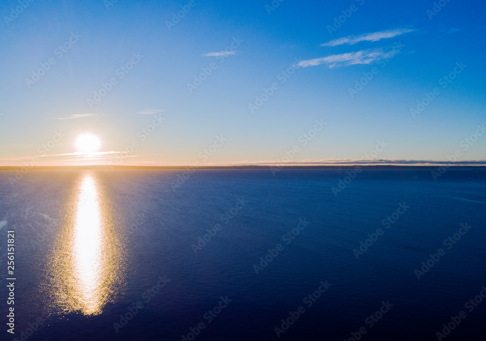 Aerial view of a Sunset sky background. Aerial Dramatic gold sunset sky with evening sky clouds over the sea. Stunning sky clouds in the sunset. Sky landscape. Aerial photography.