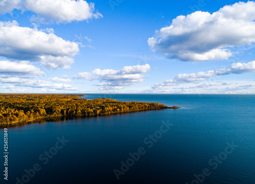 Aerial view of seashore with beach  lagoons. Coastline with sand and water. Landscape. Aerial photography. Birdseye. Sea  beach  sky  clouds. Autumn yellow trees and forest