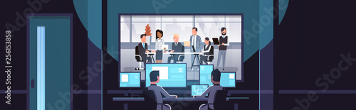 two men looking at monitors behind glass mix race business people team brainstorming meeting conference dark office interior surveillance security system flat horizontal