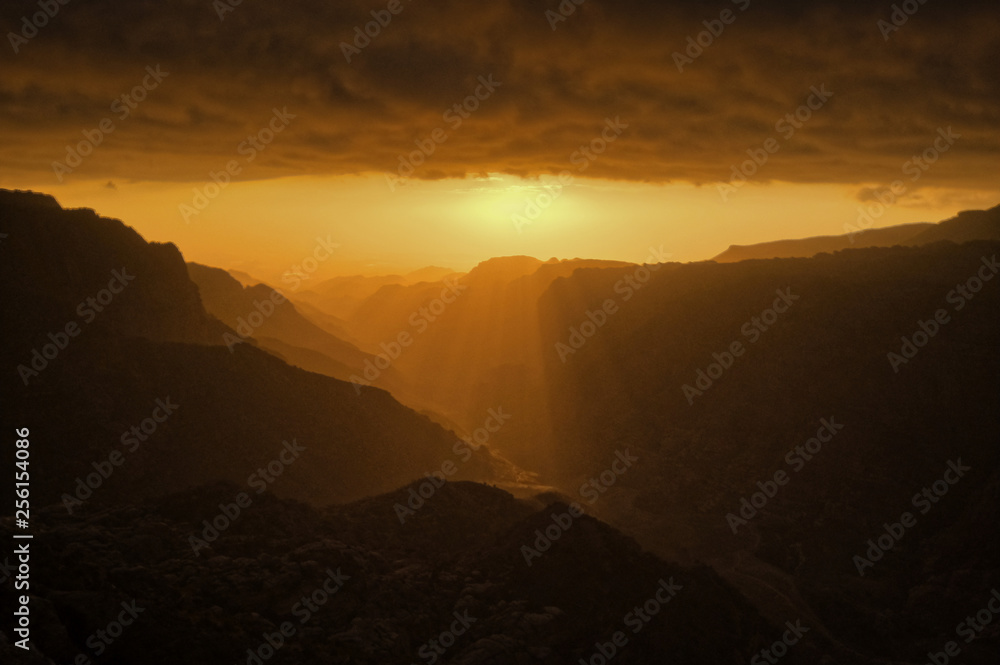 Dramatic orange sunset in Dana mountains in Jordan