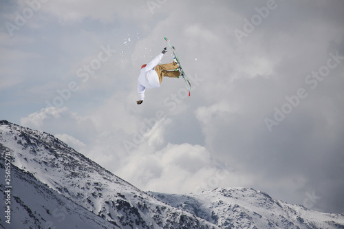 Flying skier on snowy mountains. Extreme winter sport, alpine ski.
