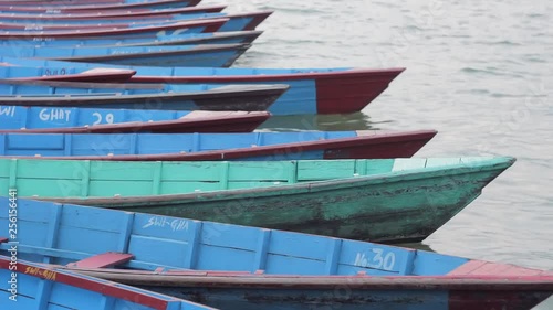 Wallpaper Mural empty wooden boats anchored at the pier swaying in the waves Torontodigital.ca
