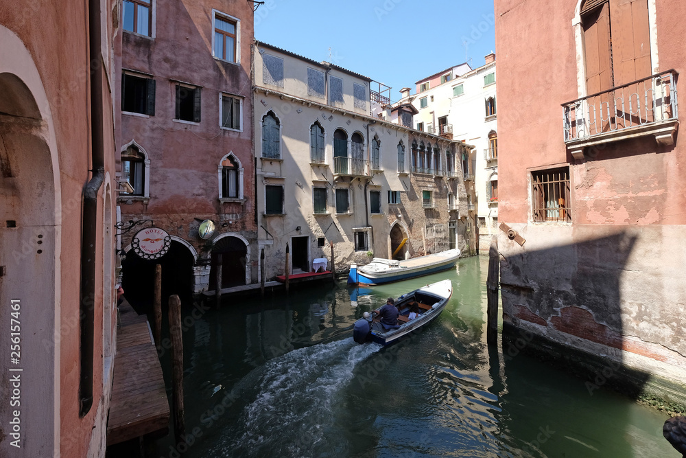 View of the beautiful and colorful small canals and historic buildings in Venice, Italy