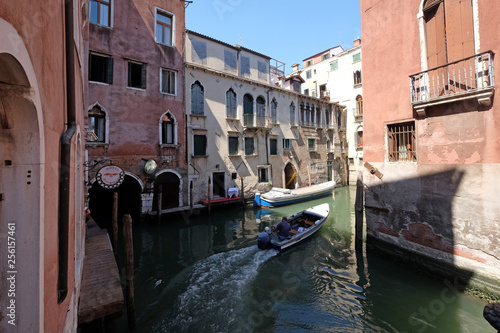 View of the beautiful and colorful small canals and historic buildings in Venice, Italy