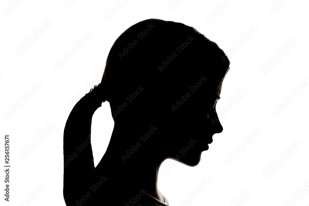 Dark silhouette profile of a young women on a white background, the concept of anonymity