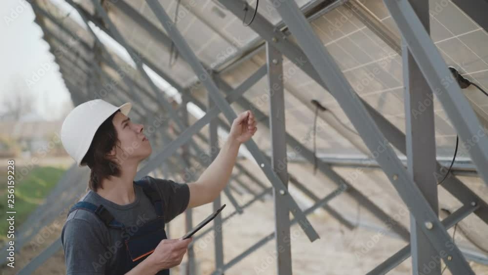 The engineer checking wiring of solar batteries. 4K The engineer checking wiring of solar batteries. 4K
