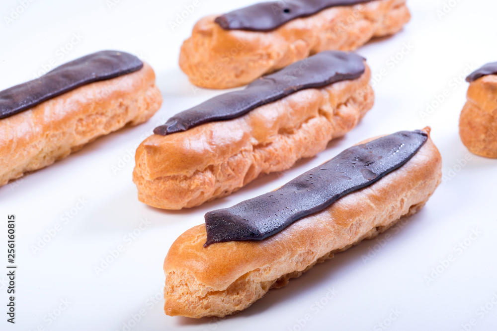 Chocolate eclairs on a white background. Close up, dessert.