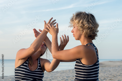 Two women are engaged in body therapy in nature