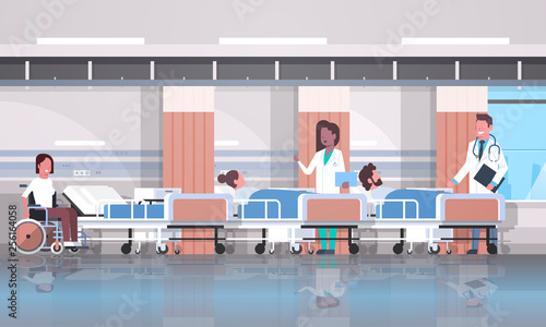 doctors team visiting disabled mix race patients sitting wheelchair lying bed intensive therapy ward healthcare concept hospital clinic room interior horizontal