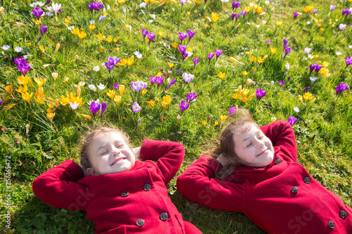 Children enjoy spring, sun and flowers.