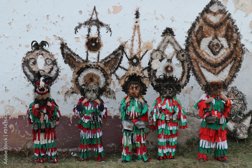 Obraz premium Zemen, Bulgaria - March 16, 2019: Masquerade festival Surva in Zemen, Bulgaria. People with mask called Kukeri dance and perform to scare the evil spirits.