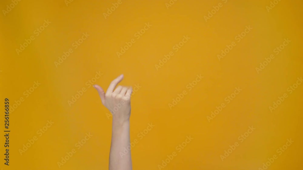 cropped view of woman showing come here gesture and pointing with finger isolated on yellow cropped view of woman showing come here gesture and pointing with finger isolated on yellow