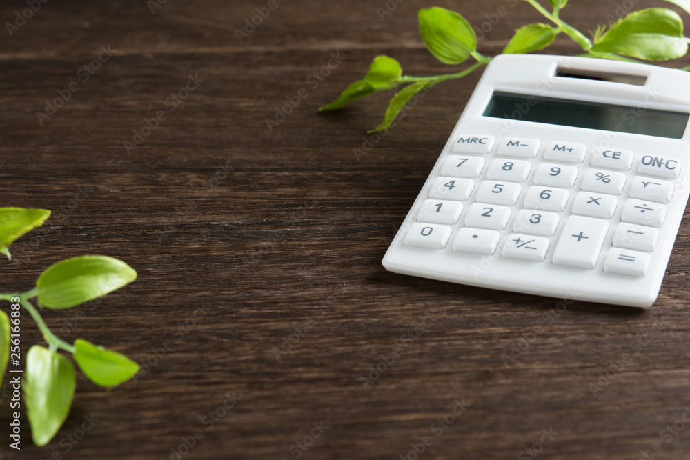 Calculator on a wooden table Calculator on a wooden table