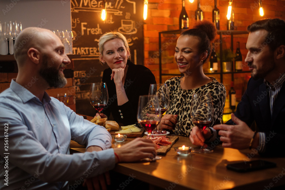 Group of friends having fun talk behind bar counter in a cafe Group of friends having fun talk behind bar counter in a cafe