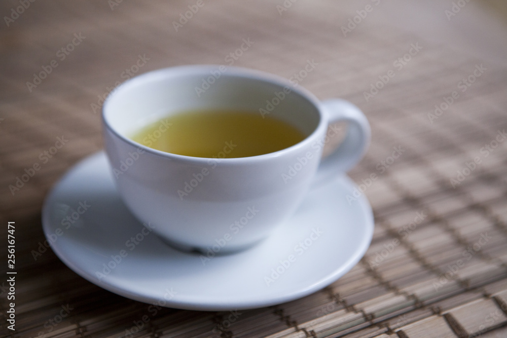 Green tea on a brown mat close-up