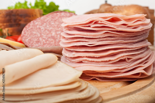 big group of thin sliced meat, bread and vegetables