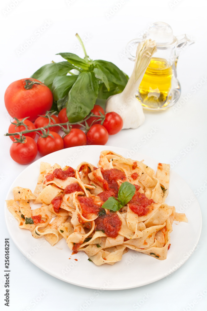 tasty pappardelle pasta with tomato marinara sauce and ingredients on white background tasty pappardelle pasta with tomato marinara sauce and ingredients on white background