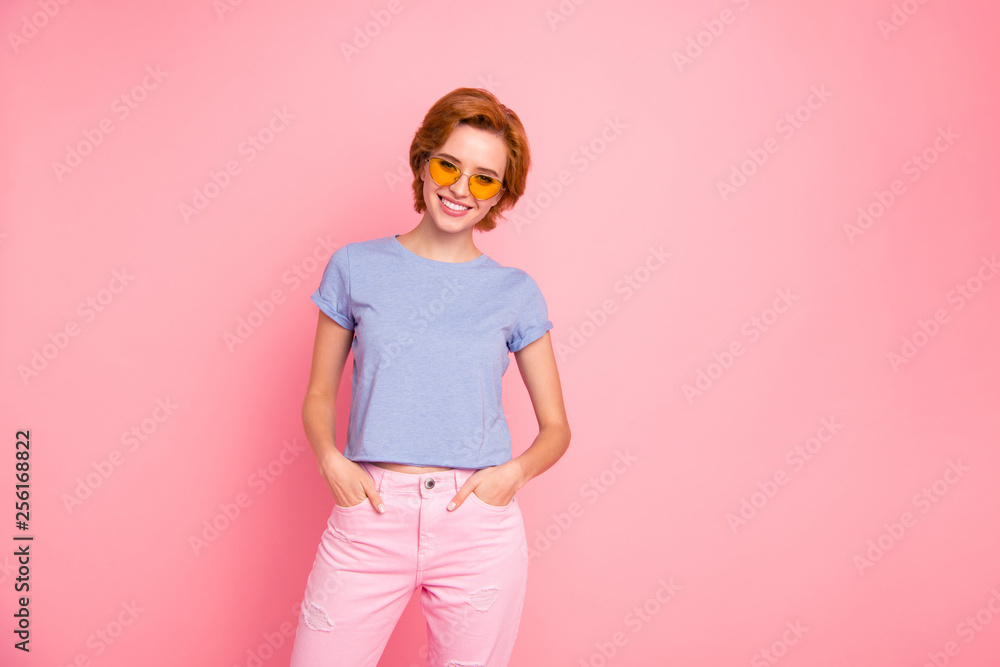 Portrait of her she nice cute charming attractive lovely cheerful cheery girl wearing casual look cool yellow glasses holding hands in pockets isolated over pink pastel background Portrait of her she nice cute charming attractive lovely cheerful cheery girl wearing casual look cool yellow glasses holding hands in pockets isolated over pink pastel background