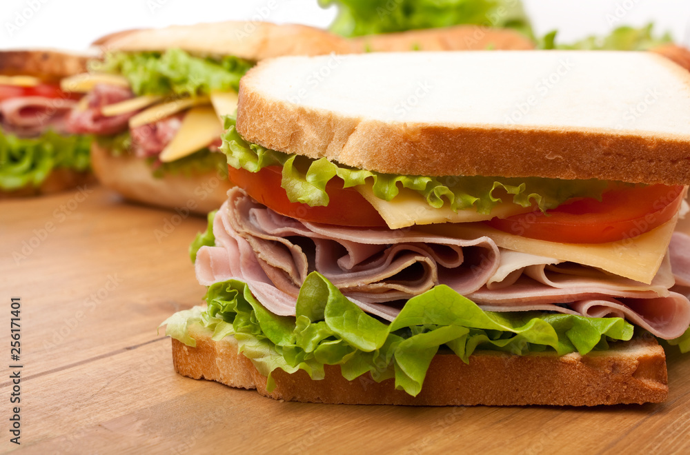 group of tasty sandwiches on a wooden table group of tasty sandwiches on a wooden table