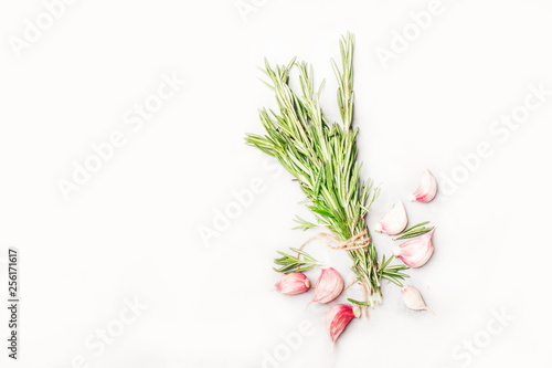Fresh rosemary and red garlic on white spice food background  top view