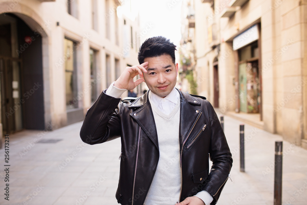 Asian young man walking down the street Asian young man walking down the street