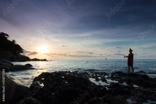 fisherman on the beach at sunset