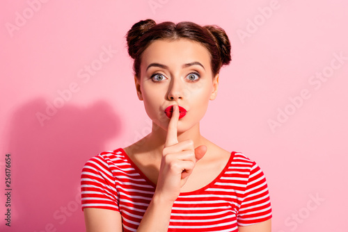 Close up photo beautiful she her lady pretty buns bright pomade lipstick arm hand finger lips asking not talk tell speak fellow friend wear casual striped red white t-shirt isolated pink background photo