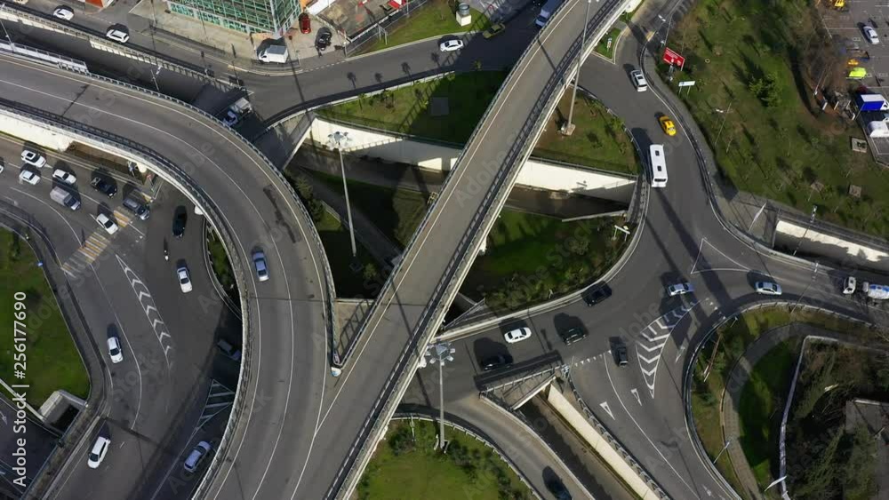 Aerial photography with quadrocopter. Camera movement in a counterclockwise direction. City traffic. The intersection of five roads. Intersection with busy traffic.