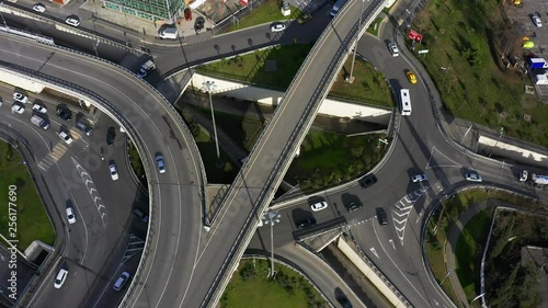 Aerial photography with quadrocopter. Camera movement in a counterclockwise direction. City traffic. The intersection of five roads. Intersection with busy traffic. photo