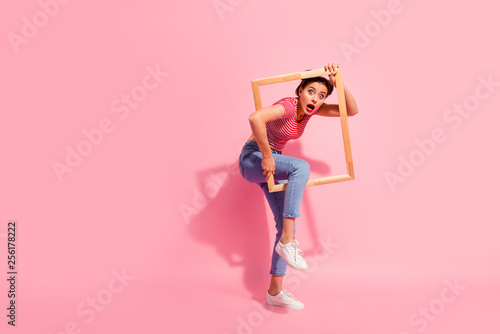 Full length body size view of her she nice cute charming attractive glamorous worried girl in casual striped t-shirt jeans trying to escape break rules borders life isolated over pink background photo