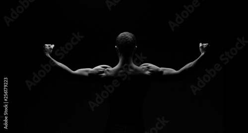 man from back on black background