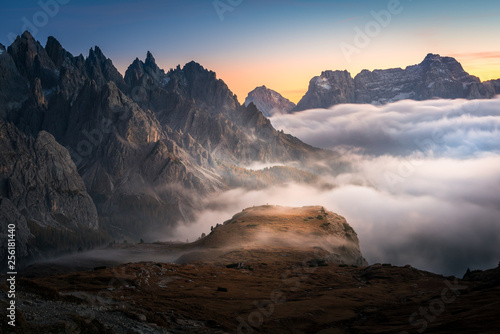 dramatic view of dolomites mountains above the clouds in the tre cime di lavaredo national park. foggy mountain landscape during sunset, South Tyrol. © evoks24