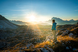 young man enjoying the view of the mountains landscape in the dolomites mountain range. tre cime di lavaredo national park, south tyrol