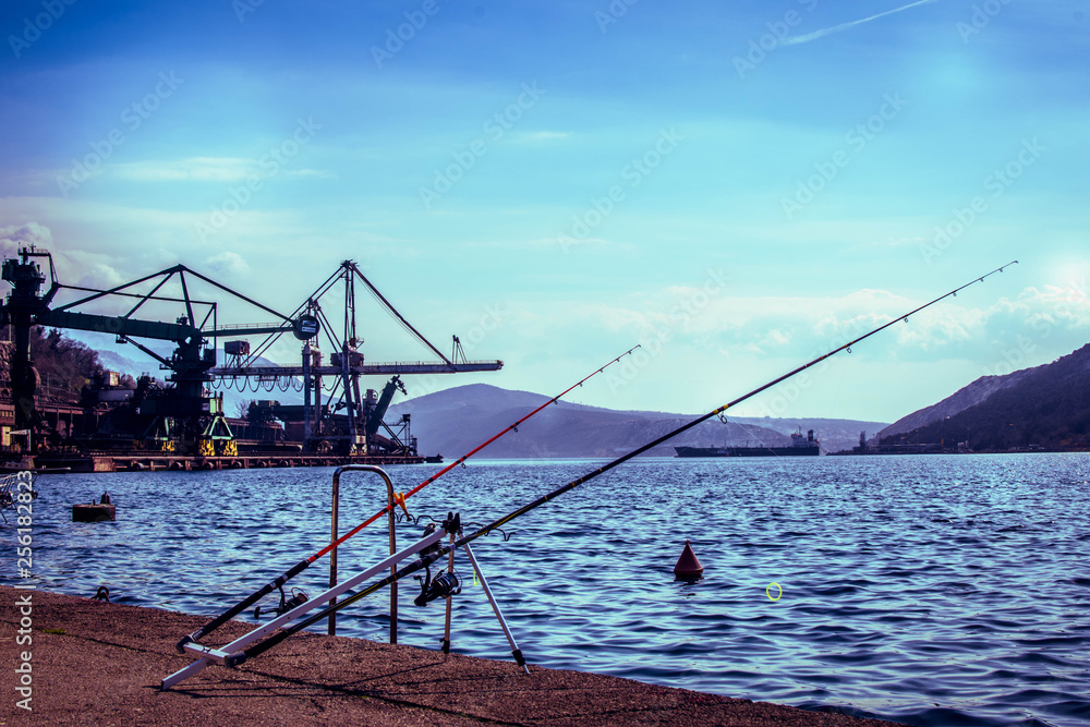 While I was walking at city Bakar I took this photo. Locals fishing at docks, and industrial at background. While I was walking at city Bakar I took this photo. Locals fishing at docks, and industrial at background.