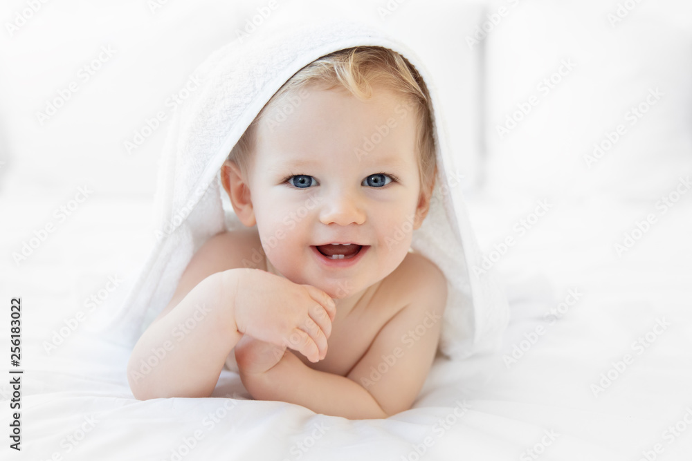 Happy toddler wrapped in towel after bath Happy toddler wrapped in towel after bath