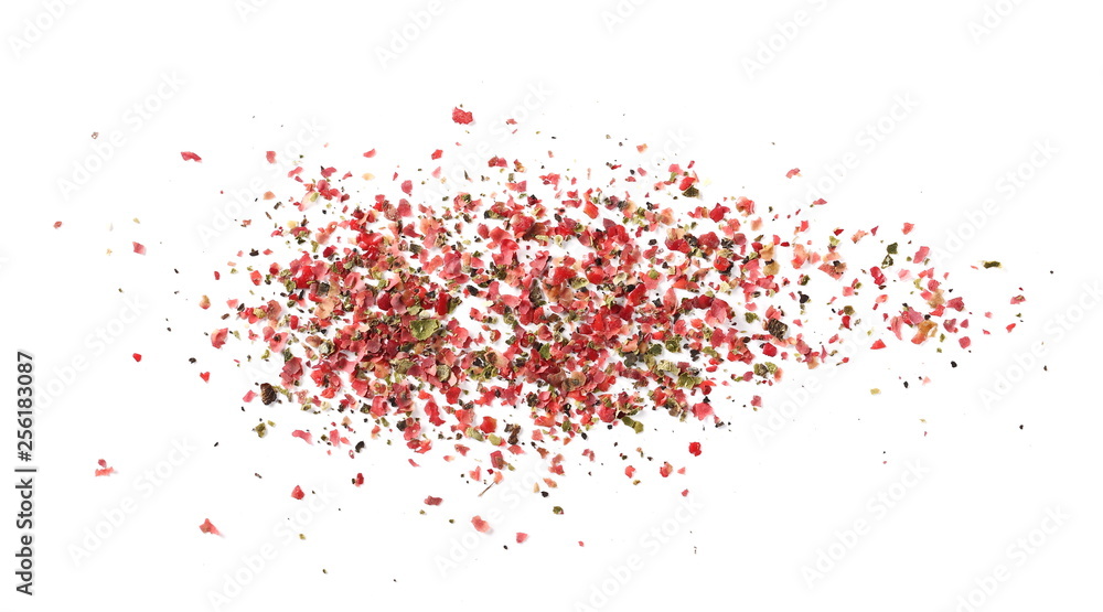 Obraz premium Colorful ground pepper grains isolated on white background, top view