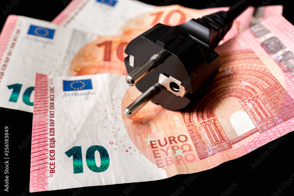 Electric power plug and european money on background Electric power plug and european money on background