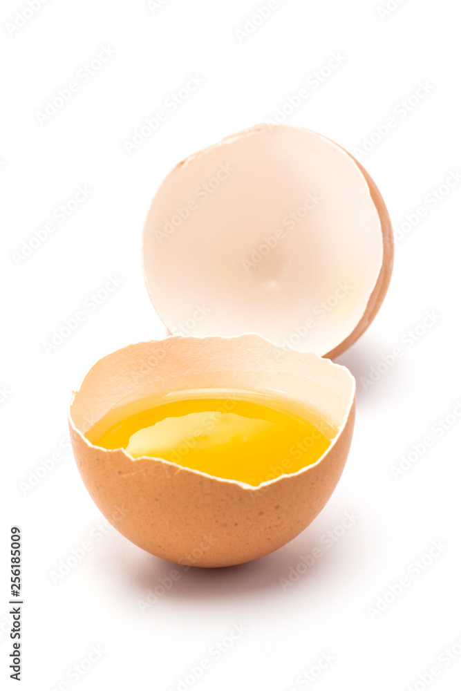 One egg stand with cracked to show yolk inside One egg stand with cracked to show yolk inside