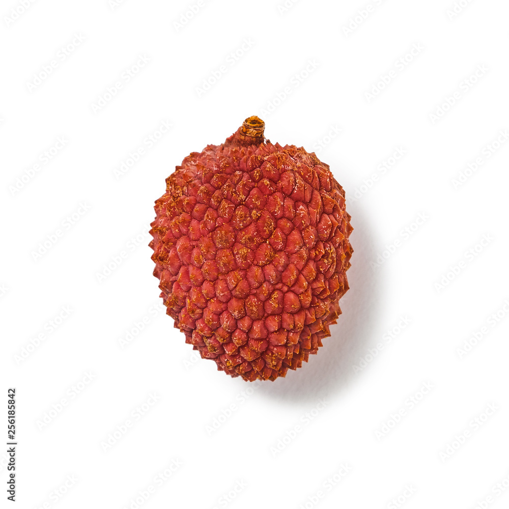 one ripe pink red lychee on a white background isolated with shadow. Side view one ripe pink red lychee on a white background isolated with shadow. Side view