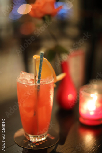 Red cocktail at bar