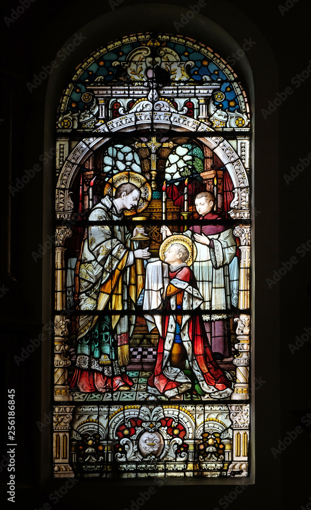 Saint Aloysius is given his first communion by Saint Charles Borromeo, stained glass window in the church of Saint Martin in Zagreb, Croatia
