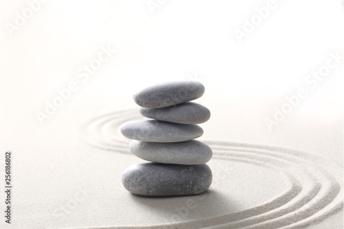 zen stone concept  grey stones piled on the sand with copy space for your text