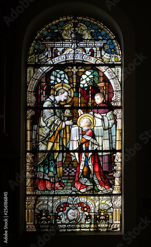Saint Aloysius is given his first communion by Saint Charles Borromeo  stained glass window in the church of Saint Martin in Zagreb  Croatia