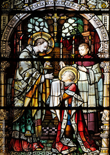 Saint Aloysius is given his first communion by Saint Charles Borromeo, stained glass window in the church of Saint Martin in Zagreb, Croatia