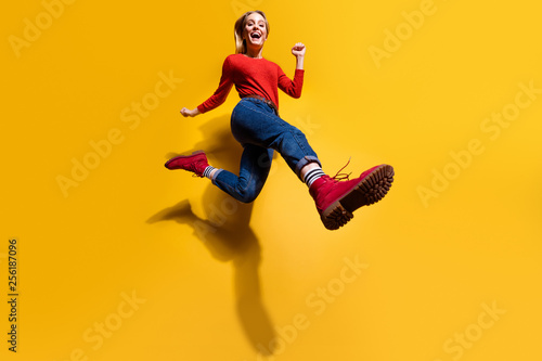 Low below angle full length body size view of nice attractive cheerful girl making step wearing vintage retro maroon burgundy footwear isolated over bright vivid shine orange background